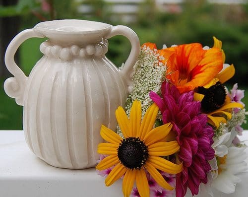 flowers including daisies with a vase