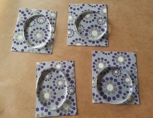 glass pendant tiles on recycled paper