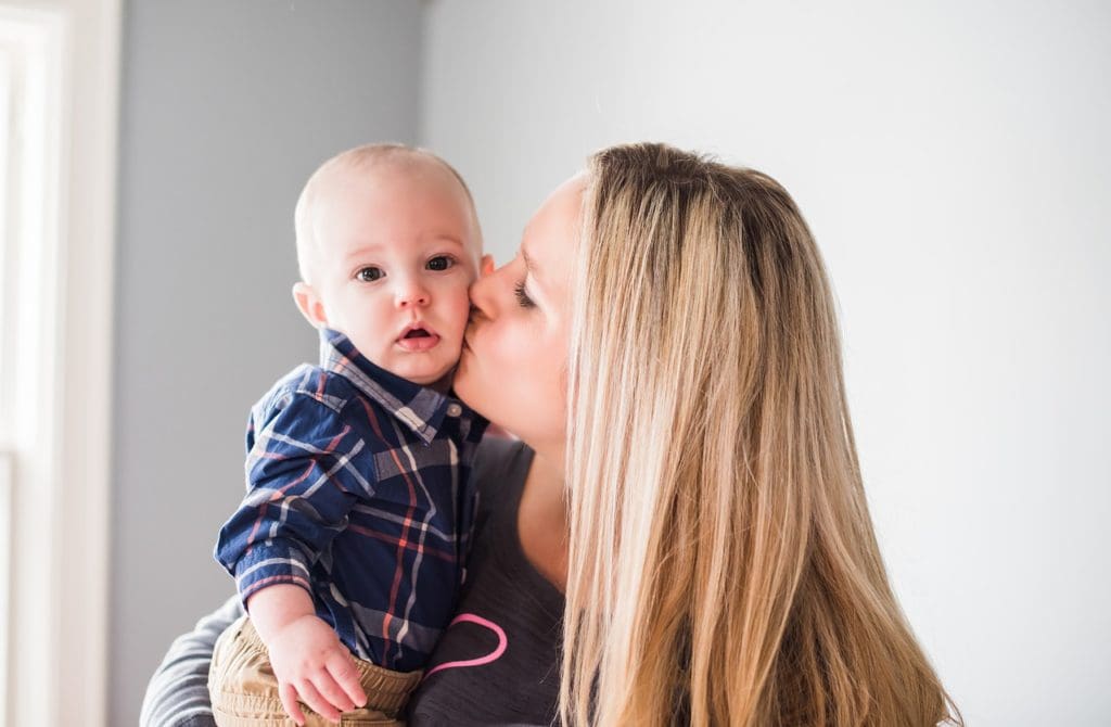 mom kissing child