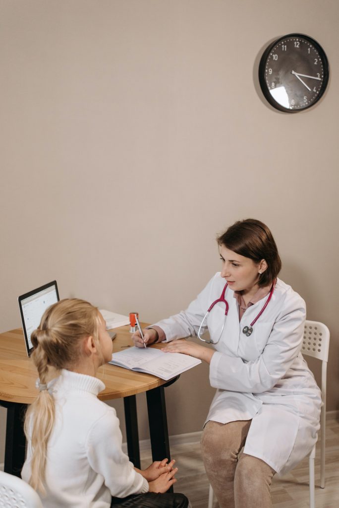 Nurse talking to young girl