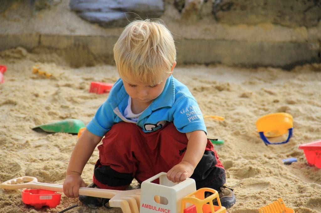 Boy playing in sandpit