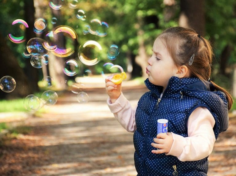 Toddler blowing bubbles