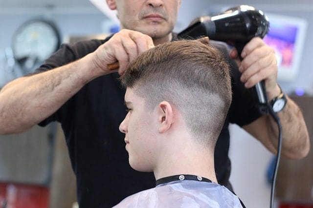 young man getting buzz cut