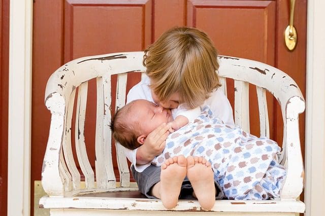 Big brother holding baby